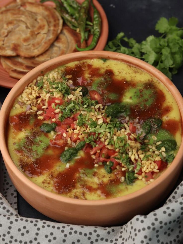 यात हे असू शकते: फटाके आणि ब्रेडच्या शेजारी टेबलच्या वर बसलेल्या अन्नाने भरलेल्या दोन वाट्या