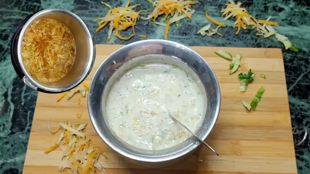 लाकडाच्या कटिंग बोर्डवर स्टेनलेस स्टीलच्या भांड्यात किसलेल्या बाटलीत मिसळलेले मलईदार दही.
