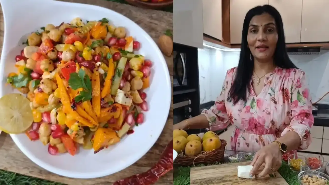 : एक महिला स्वयंपाकघरात चणे, आंब्याचे तुकडे, डाळिंबाचे दाणे आणि ताजे पनीर असलेले रंगीत प्रोटीन सॅलड तयार करते.