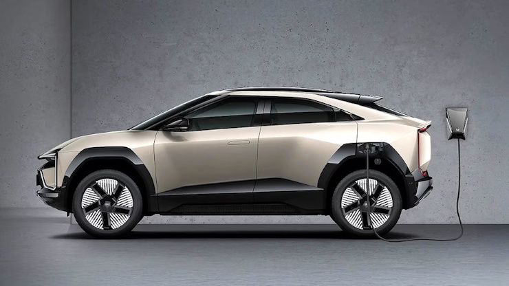 Mahindra Be 6 इलेक्ट्रिक SUV राखाडी भिंतीवर चार्ज होत आहे Mahindra Be 6 इलेक्ट्रिक SUV राखाडी भिंतीवर चार्ज होत आहे